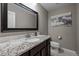 Elegant bathroom with granite countertop, dark wood vanity, and framed mirror at 15220 E Caley Ave, Centennial, CO 80016