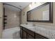 Bathroom features tile backsplash, granite countertop, and dark wood vanity at 15220 E Caley Ave, Centennial, CO 80016