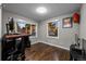 Cozy bedroom with hardwood floors, two windows providing natural light, and neutral wall color at 15220 E Caley Ave, Centennial, CO 80016