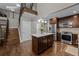 Updated kitchen with island, stainless appliances, dark cabinets and hardwood floors at 15220 E Caley Ave, Centennial, CO 80016