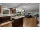 Open concept kitchen with hardwood floors, island, and stainless steel appliances at 15220 E Caley Ave, Centennial, CO 80016