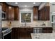 Spacious kitchen with granite countertops, backsplash, and stainless steel dishwasher at 15220 E Caley Ave, Centennial, CO 80016