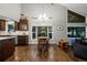Open-concept living area featuring hardwood floors, modern chandelier, and large windows for lots of natural light at 15220 E Caley Ave, Centennial, CO 80016