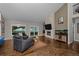 Spacious living room with fireplace, hardwood floors, and access to the outdoor area at 15220 E Caley Ave, Centennial, CO 80016