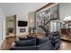 Bright living room showcasing an open floor plan with a stone fireplace and a staircase to the second floor at 15220 E Caley Ave, Centennial, CO 80016