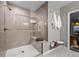Tiled walk-in shower features a built-in bench, glass enclosure, and decorative niche at 15220 E Caley Ave, Centennial, CO 80016