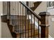 Detailed staircase with dark wood treads, decorative wrought iron railings, and white risers at 15220 E Caley Ave, Centennial, CO 80016
