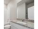 Bright bathroom featuring a granite countertop vanity, large mirror, and a shower-tub combination at 709 Twining Ave, Brighton, CO 80601