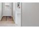 Inviting entryway with stylish wood floors transitioning to plush carpeting, offering a warm welcome at 709 Twining Ave, Brighton, CO 80601