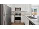 Modern kitchen featuring stainless steel appliances, granite countertops, and white cabinets at 709 Twining Ave, Brighton, CO 80601