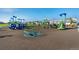 Community playground offers green and blue play equipment for children to enjoy with neighborhood views at 709 Twining Ave, Brighton, CO 80601