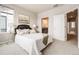 Inviting bedroom features a plush bed, soft lighting, and en-suite bathroom access at 19714 W 93Rd Ln # C, Arvada, CO 80007