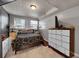 Finished basement bedroom with wood flooring and a large dresser for storage at 8710 Alta Vista Dr, Arvada, CO 80004