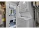 Laundry room that leads to a bathroom with toilet and a window at 8710 Alta Vista Dr, Arvada, CO 80004