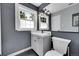 Bathroom with modern vanity, mirror, black and white flooring, and natural light at 8710 Alta Vista Dr, Arvada, CO 80004
