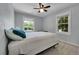 Bright bedroom with a ceiling fan, two windows and plush carpeting at 8710 Alta Vista Dr, Arvada, CO 80004