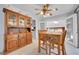 Dining room with a wooden table, four chairs, ceiling fan and a classic hutch for storage and display at 8710 Alta Vista Dr, Arvada, CO 80004