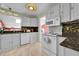 White kitchen featuring ample counter space, cabinets, and modern appliances at 8710 Alta Vista Dr, Arvada, CO 80004