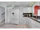 Bright kitchen featuring white cabinets, appliances and marble-style flooring at 8710 Alta Vista Dr, Arvada, CO 80004