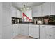 Well-lit kitchen with white appliances, mosaic backsplash, and plenty of storage at 8710 Alta Vista Dr, Arvada, CO 80004