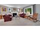 Comfortable living room with a fireplace, plush seating, large window, and decorative wallpaper for a cozy ambiance at 8710 Alta Vista Dr, Arvada, CO 80004