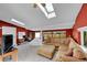Spacious living room featuring a skylight and comfortable seating area with large windows at 8710 Alta Vista Dr, Arvada, CO 80004