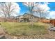 Expansive fenced backyard featuring a covered patio and a spacious lawn, perfect for outdoor gatherings at 5264 E 129Th Pl, Thornton, CO 80241