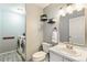 Convenient half bathroom with laundry area, neutral tones, and stylish shelving at 5264 E 129Th Pl, Thornton, CO 80241