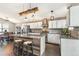 Modern kitchen with hardwood floors, stainless steel appliances, white cabinets, brick backsplash, and island seating at 5264 E 129Th Pl, Thornton, CO 80241