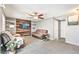 Cozy living room with wood accent wall, plush seating, and modern ceiling fan at 5264 E 129Th Pl, Thornton, CO 80241