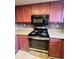 Kitchen featuring updated appliances, stylish cabinetry, and granite countertops at 14989 E Pacific Pl, Aurora, CO 80014