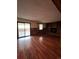 Spacious living room with a sliding glass door, fireplace, hardwood floors and a backyard view at 14989 E Pacific Pl, Aurora, CO 80014