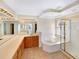 Main bathroom with a soaking tub, glass enclosed shower, and double sink vanity at 18951 E 43Rd Ave, Denver, CO 80249