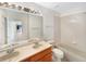 Well-lit bathroom with double sinks, a large mirror, and a tub-shower combo at 18951 E 43Rd Ave, Denver, CO 80249