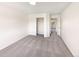 Minimalist bedroom with neutral carpet, white walls, closet and view to another room at 18951 E 43Rd Ave, Denver, CO 80249