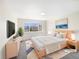 Bright bedroom with a large window offering neighborhood views and stylish furniture at 18951 E 43Rd Ave, Denver, CO 80249