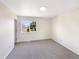 Minimalist bedroom with a large window offering natural light and view of the outdoors at 18951 E 43Rd Ave, Denver, CO 80249