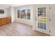 Bright dining area with hardwood floors, large windows, and a door leading to the backyard at 18951 E 43Rd Ave, Denver, CO 80249