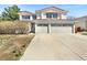 Two-story home with a red tile roof and a spacious three-car garage at 18951 E 43Rd Ave, Denver, CO 80249