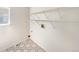 Bright laundry room with ample shelving and patterned tile floors at 18951 E 43Rd Ave, Denver, CO 80249
