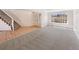 Open living space with hardwood and carpet flooring, leading to a staircase at 18951 E 43Rd Ave, Denver, CO 80249