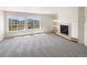 Bright living room with large windows, a fireplace, and carpeted floors at 18951 E 43Rd Ave, Denver, CO 80249