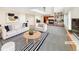 Bright living room featuring modern decor, a fireplace, and built-in bookshelves at 18951 E 43Rd Ave, Denver, CO 80249