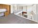Loft area with a white railing overlooking a cozy living space with a fireplace at 18951 E 43Rd Ave, Denver, CO 80249