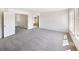Large main bedroom with carpeted floors, ensuite bathroom, and bright natural light at 18951 E 43Rd Ave, Denver, CO 80249