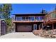 Charming two-story home features a spacious deck with mountain views and a convenient garage, nestled in a serene setting at 617 Hummingbird Trl, Idaho Springs, CO 80452