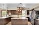 Modern kitchen boasts stainless steel appliances, granite countertops, and a center island, creating a chef's dream space at 617 Hummingbird Trl, Idaho Springs, CO 80452