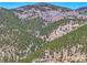 Aerial view showing mountain scenery with lush forests and homes nestled in the landscape at 617 Hummingbird Trl, Idaho Springs, CO 80452