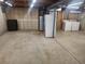 Unfinished basement with mechanicals, including a washer, dryer, and water heater at 6961 E Arkansas Ave, Denver, CO 80224