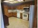 Functional kitchen featuring wooden cabinets and white appliances at 6961 E Arkansas Ave, Denver, CO 80224